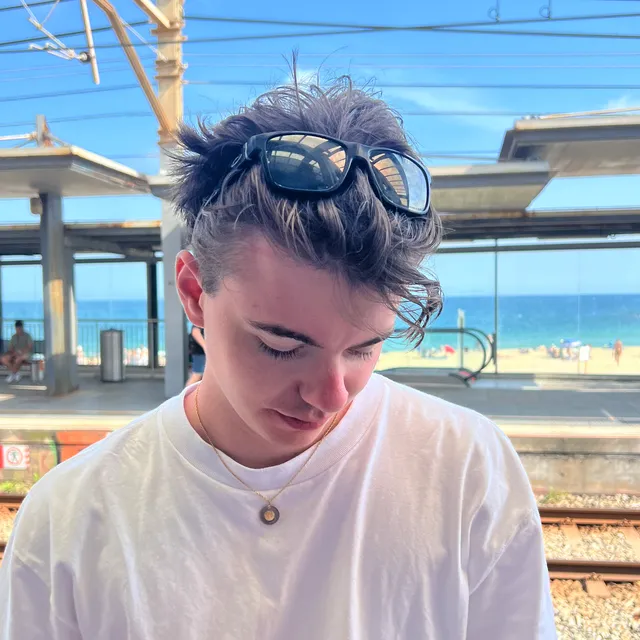 Portrait of Luca Martinet on a seaside train platform